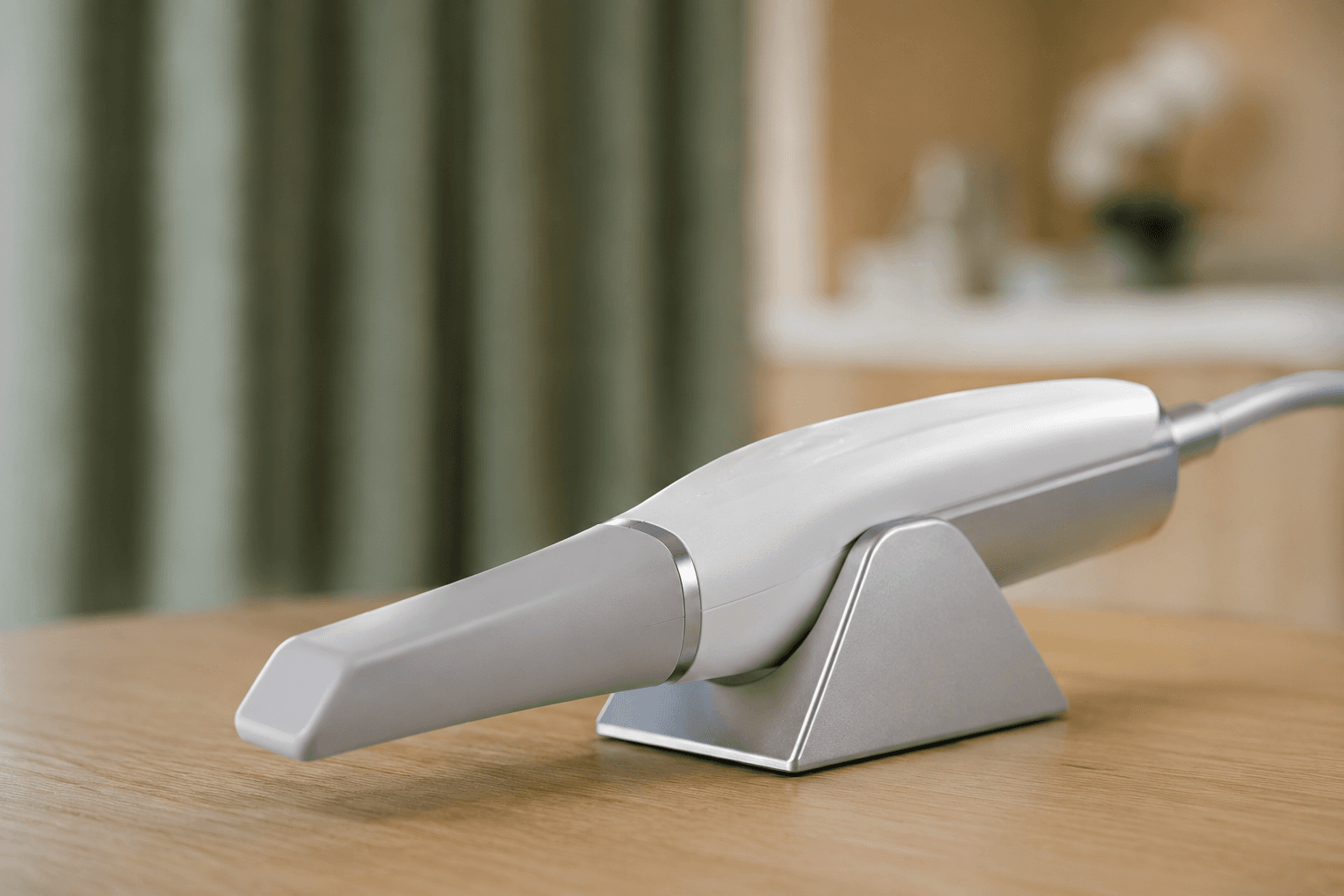 iTero Element 5D intraoral scanner wand on a light-oak countertop